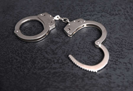 handcuffs on the black table background