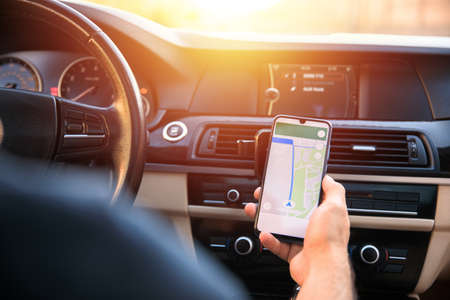 man holding mobile phone with map gps navigation