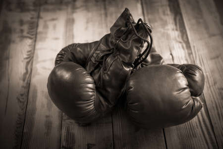 Boxing glove on a wooden table backgroundの写真素材