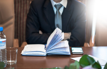 business man with notepad and phone on tableの写真素材