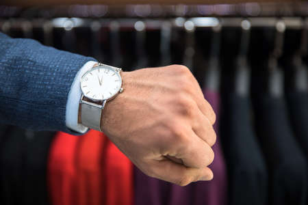 man hand clock in clothing shop backgroundの写真素材