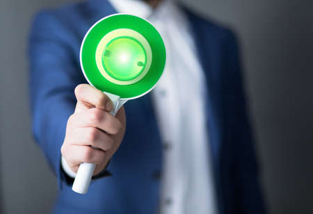 man holding green up go signの写真素材