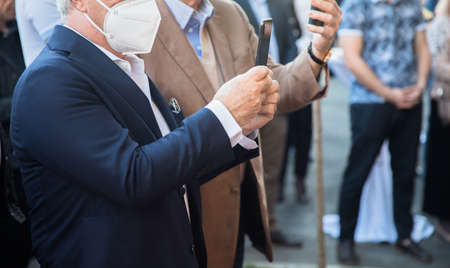 man holding phone with medical mask in face
