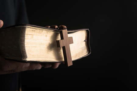prayer man holding Holy Bilbe with crossの写真素材