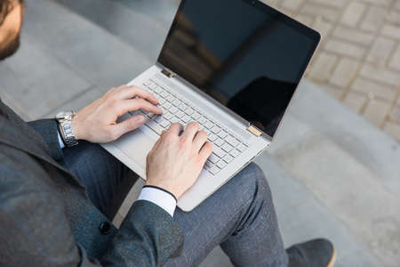 man working in computer in streetの写真素材