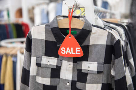 sale sign with clothes in shopの写真素材