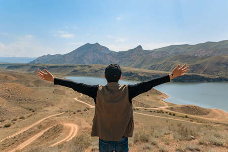man hiker at the top and observe the nature