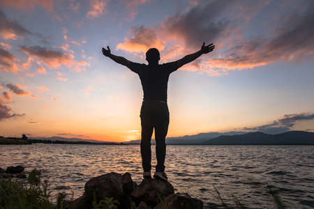 Man in the beach at the sunset.