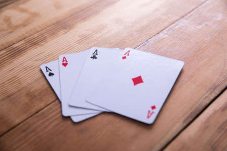 Four aces on the wooden background.の写真素材