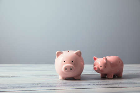Finance, saving money. Stack two white piggy banksの写真素材