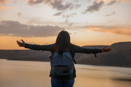happy woman in the lake at the sunset backgroundの写真素材