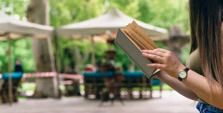woman reading book in nature backgroundの写真素材