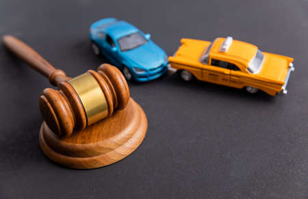 Judge gavel and two cars colliding, traffic accidentの写真素材