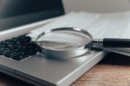 Laptop computer with magnifying glass. internet search concept.の写真素材