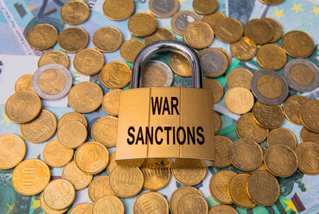 war sanctions text on lock with coinsの写真素材