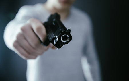 man hand gun on dark backgroundの写真素材