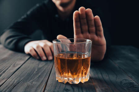 Young man with a gesture refuses alcoholの写真素材