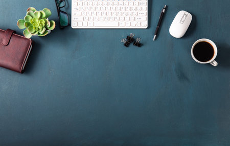 computr keyboard with stationary and coffee on working tableの写真素材