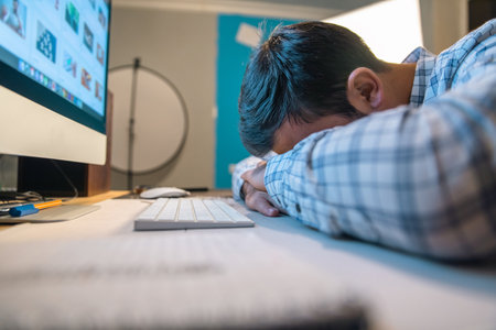 young sad tired man in office desk