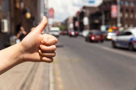 Man finger with hitchhiking the road conceptの写真素材
