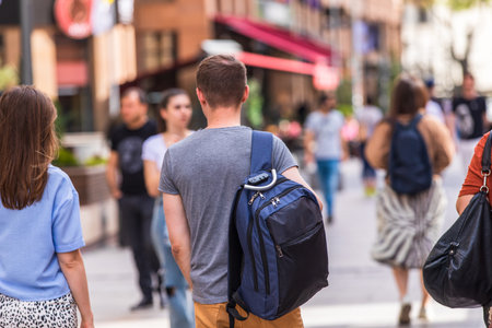 man walking on crowded city streetの写真素材