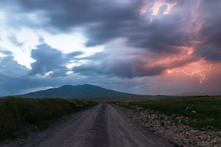 lightning at the sunset with mountains