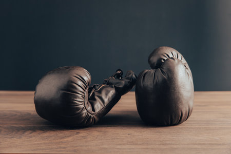 Two leather boxing gloves on the tableの写真素材