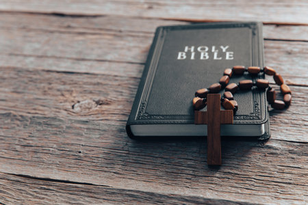 Cross and bible on a wooden table