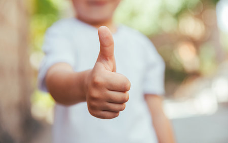 The little guy shows a thumbs up. no faceの写真素材