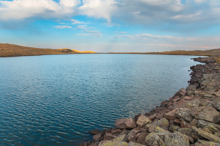 rocky shore of a blue lakeの写真素材
