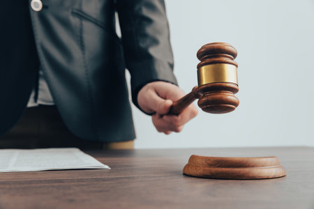 A man holds a judge's gavel. The court's decisionの写真素材