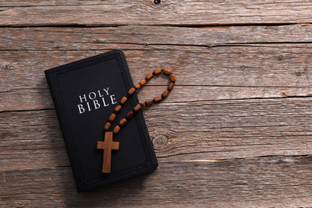 Cross and bible on a wooden table