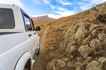 SUV stands in a dry, mountainous areaの写真素材