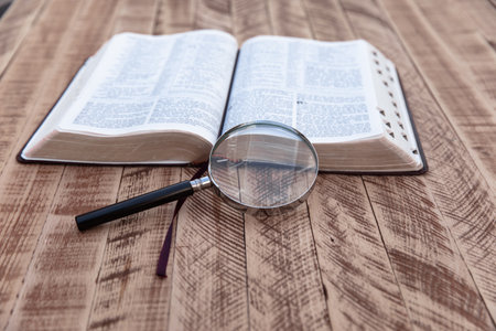 Book and magnifying glass on the table