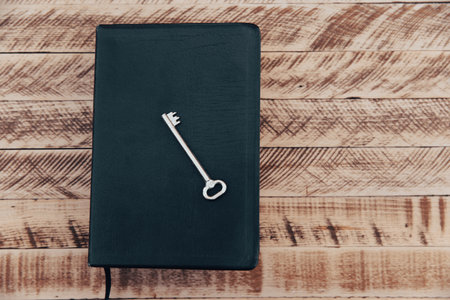 Book and keys on a wooden tableの写真素材