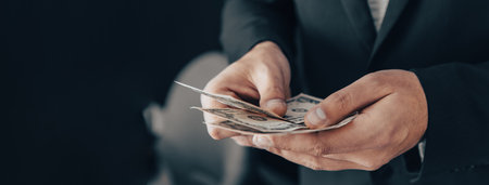 Man holding dollar bills in his handの写真素材
