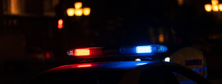 Police car with flashing lights on at nightの写真素材