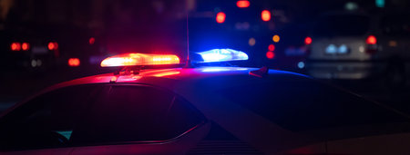 Police car with flashing lights on at nightの写真素材