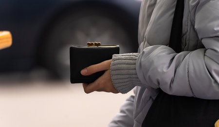 Holds a wallet in his hand on the streetの写真素材