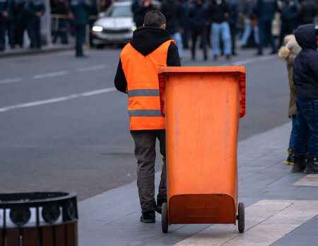 City cleaner dragging a trash can around the cityの写真素材