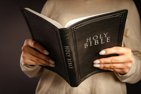 A woman holds a bible in her hand. believerの写真素材