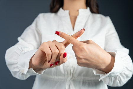 Woman showing stop with fingersの写真素材