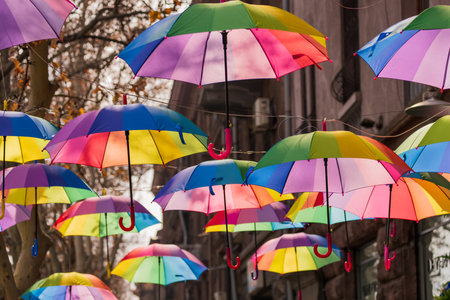 Open beautiful umbrellas hang in the airの写真素材