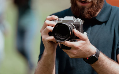 Man holding a vintage camera in his handの写真素材