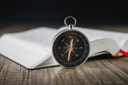 Book and compass on the table. concept direction world viewの写真素材