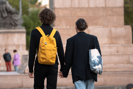Young couple walking around the city holding handsの写真素材