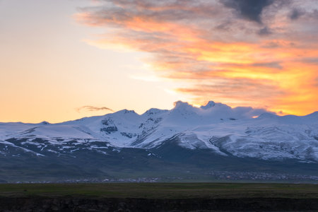 Mountain covered with snow at sunsetの写真素材