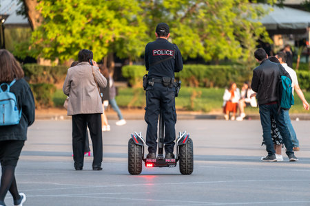 A policeman on a hoverboard rides around the cityの写真素材