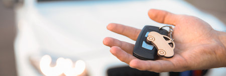 man holding car key in car backgroundの写真素材