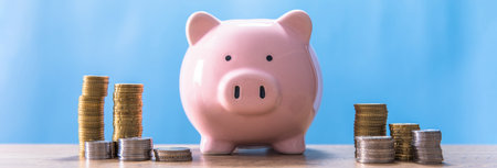 finance concept, piggy bank with coins on tableの写真素材